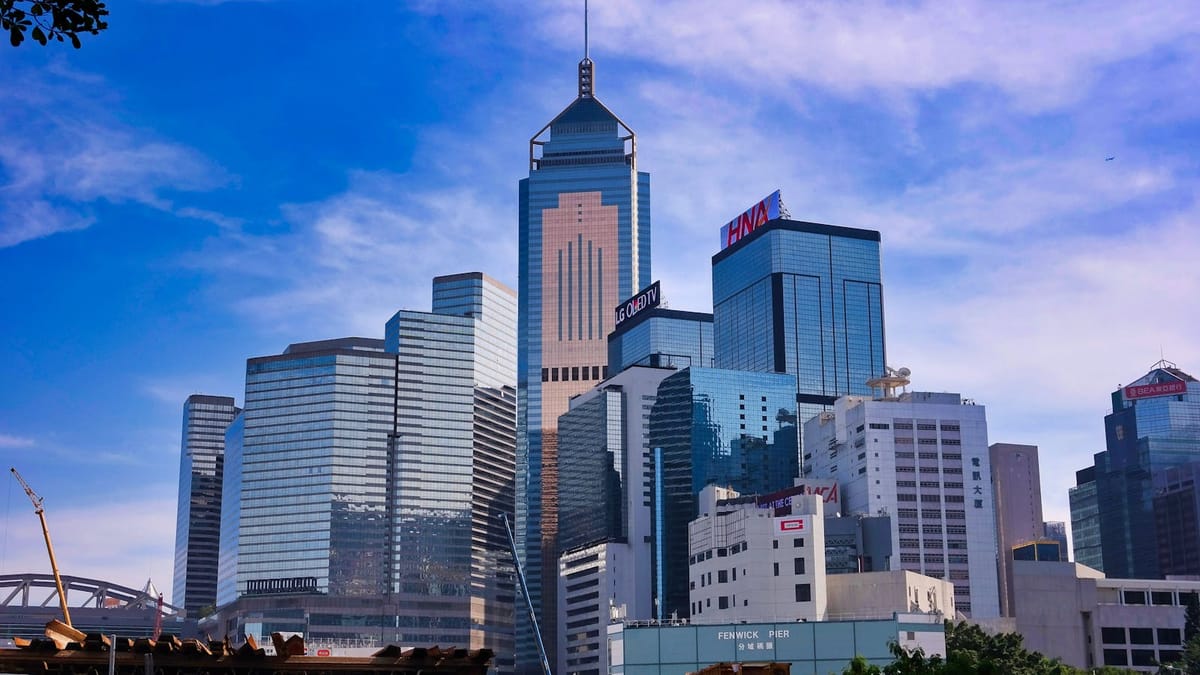 Hong Kong's Central and Wan Chai business district skyline under a clear blue sky — the international base for a French consultant's Hong Kong company
